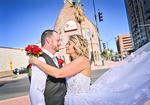A just married couple standing outside the Vegas Weddings chapel on their wedding day