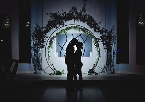A romantic photo of a just married couple standing on the aisle at their wedding in Las Vegas
