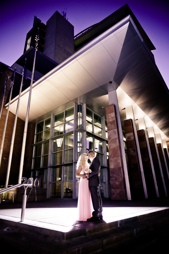 Newlyweds standing in front of Las Vegas Marriage License Bureau
