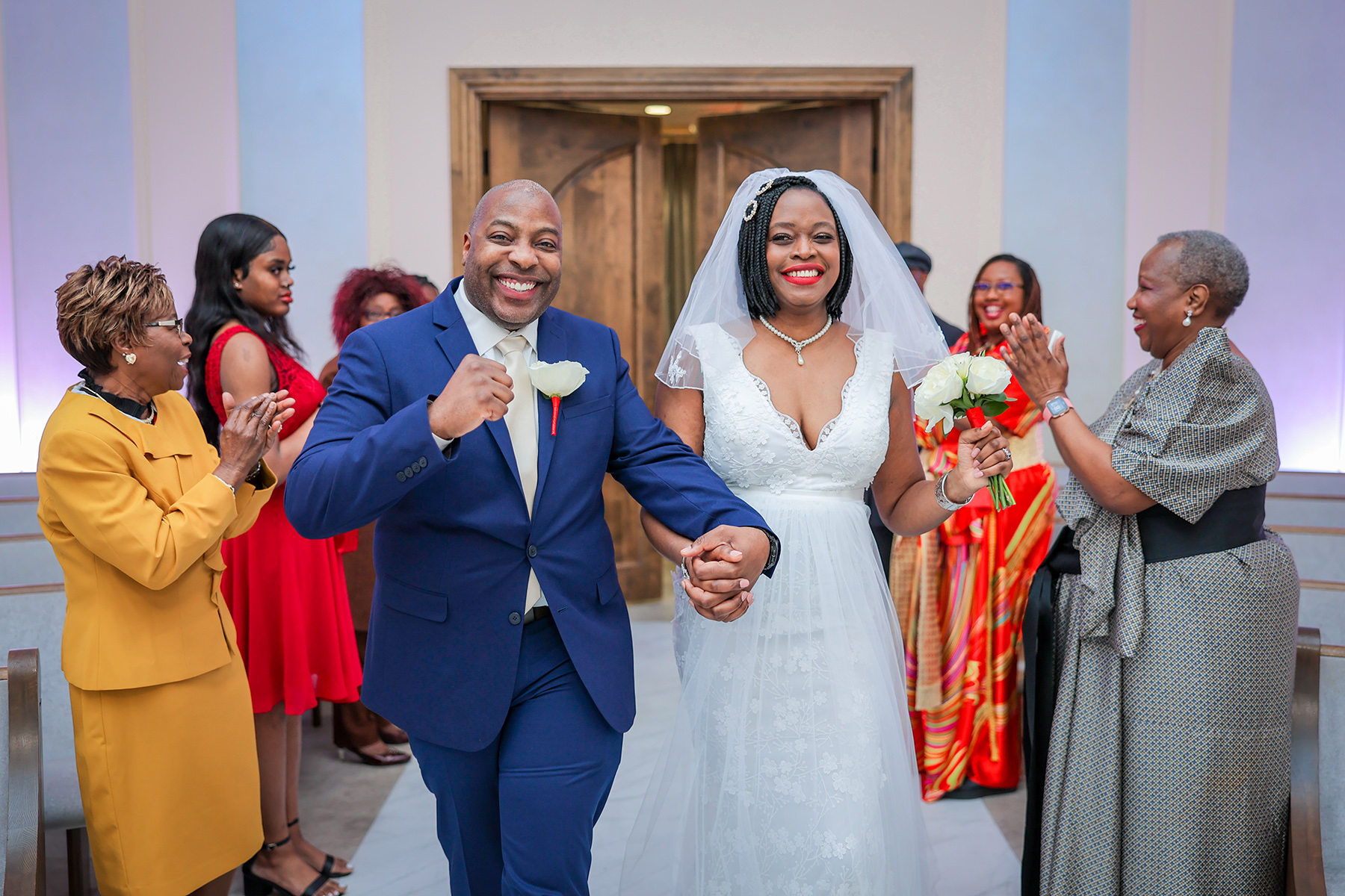 A happy couple walking down the aisle at a chapel in Las Vegas