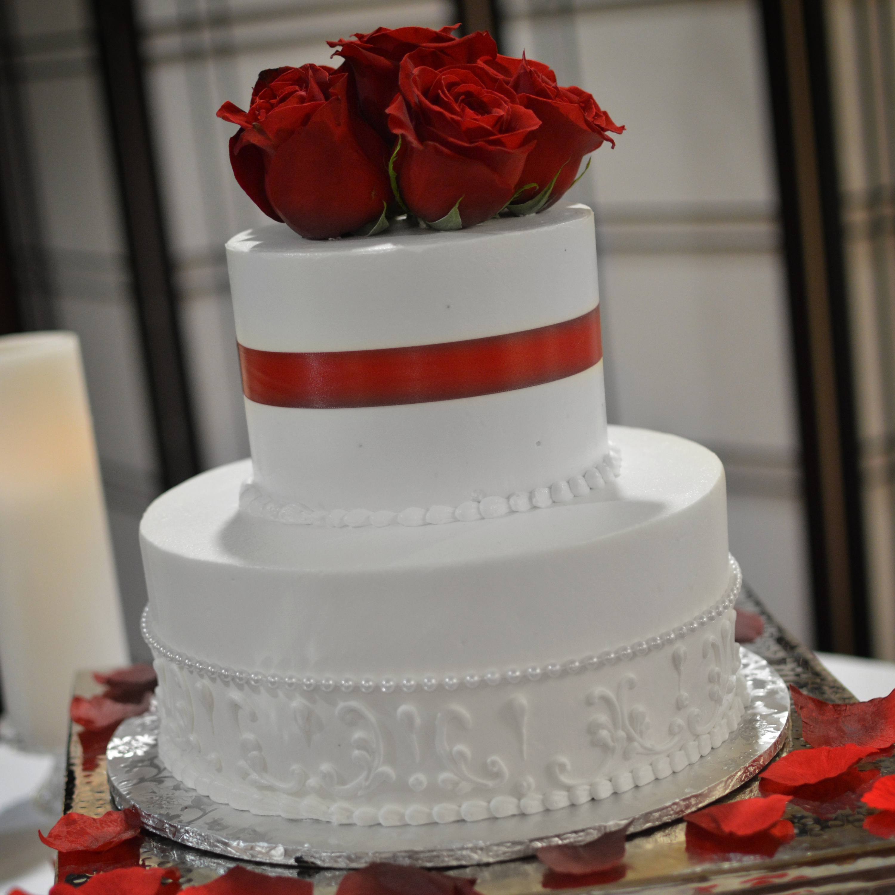 Modern elegance two tier wedding cake with red roses on the top