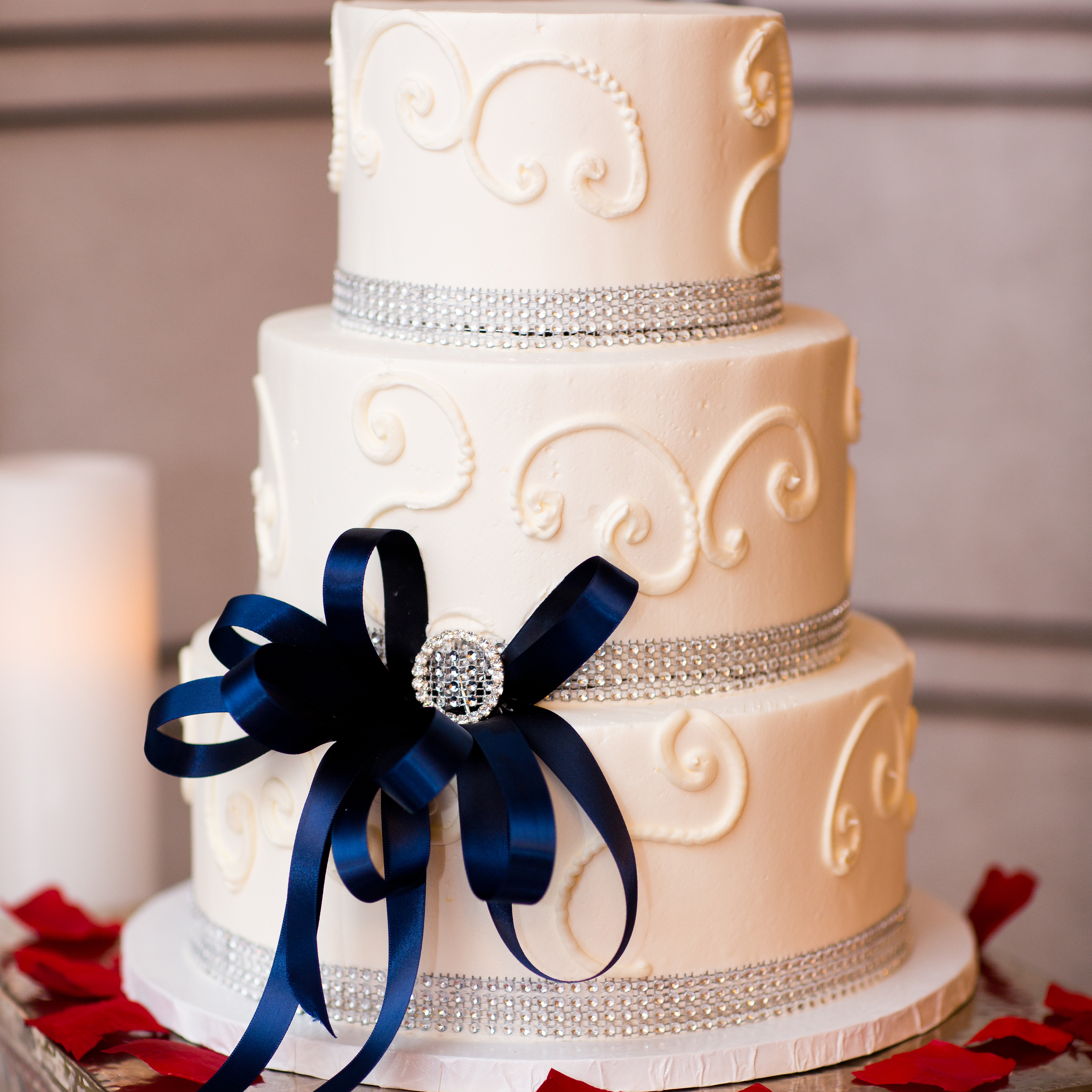 Three tier elegant wedding cake with beautiful blue ribbon