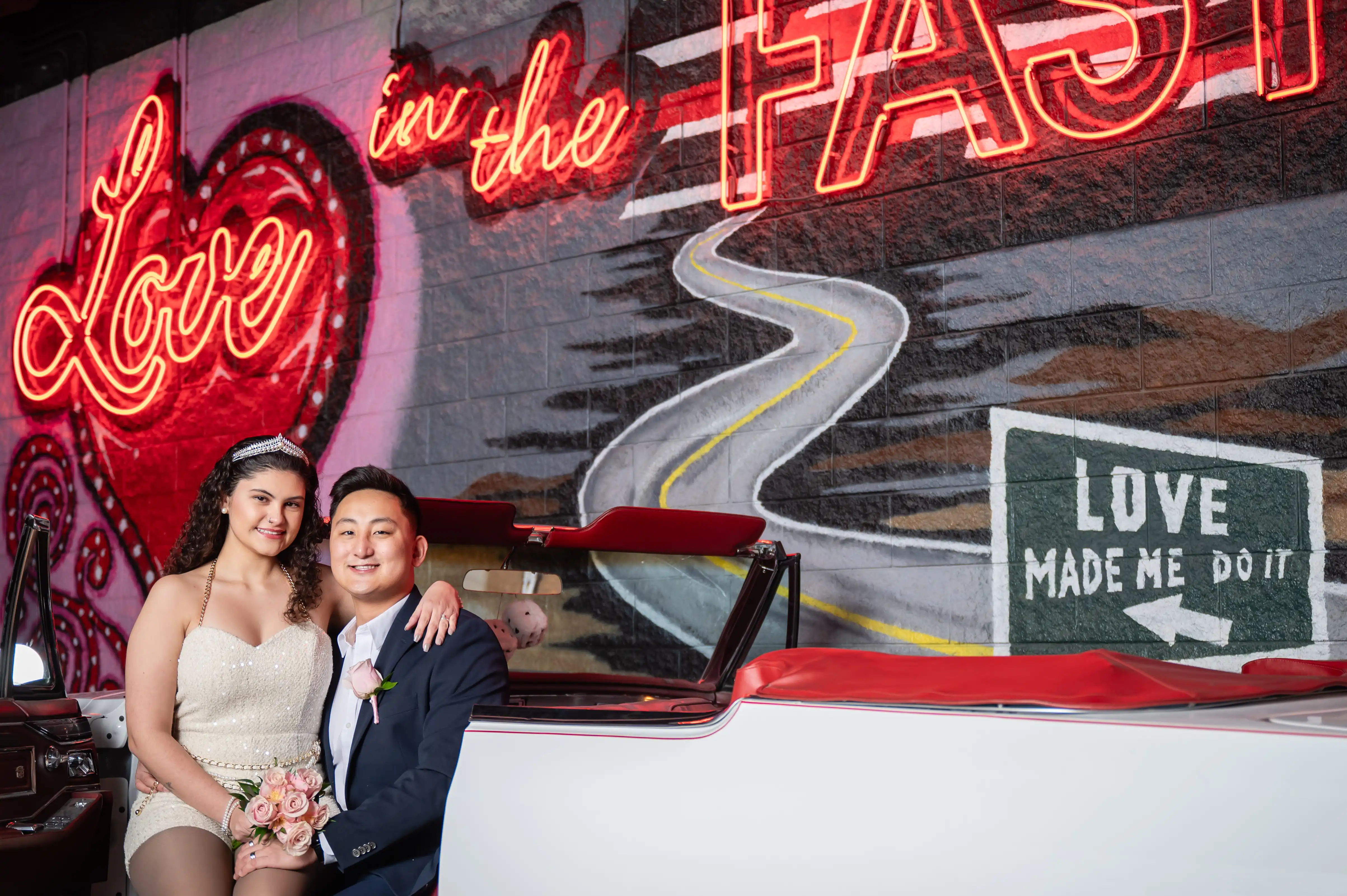 Couple celebrating their wedding ceremony in a white Cadillac at Liberty Lane in Las Vegas