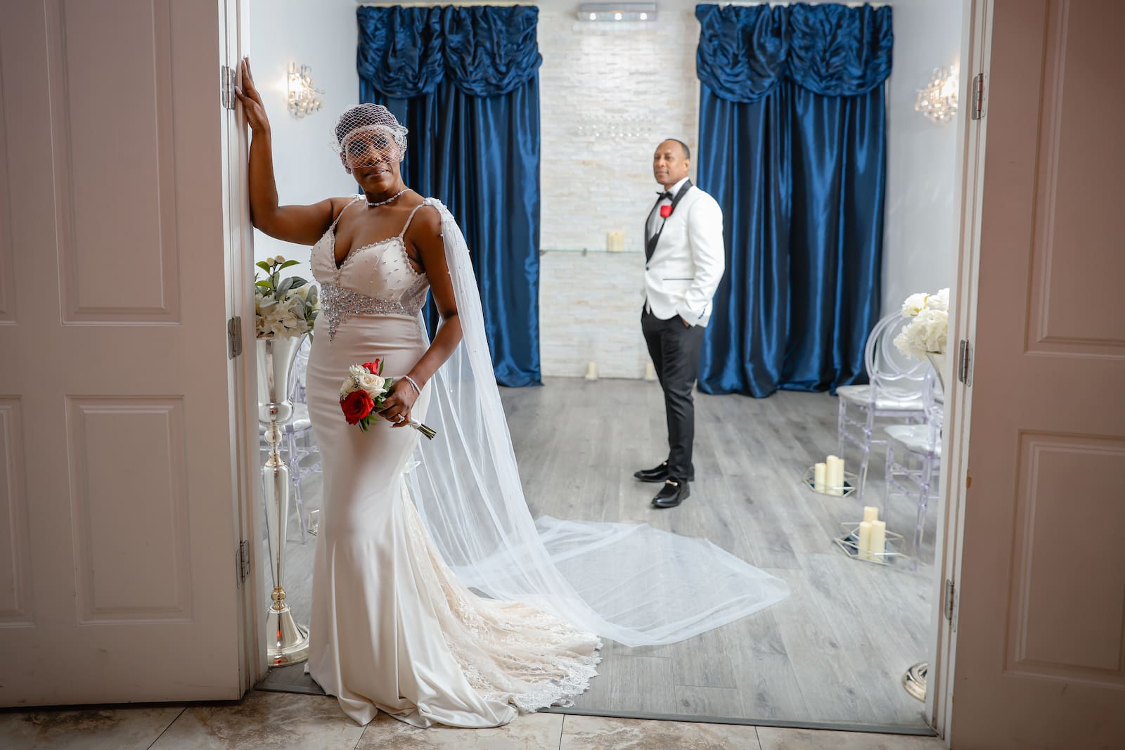 Newlyweds romantically touch foreheads in their gorgeously lit wedding chapel