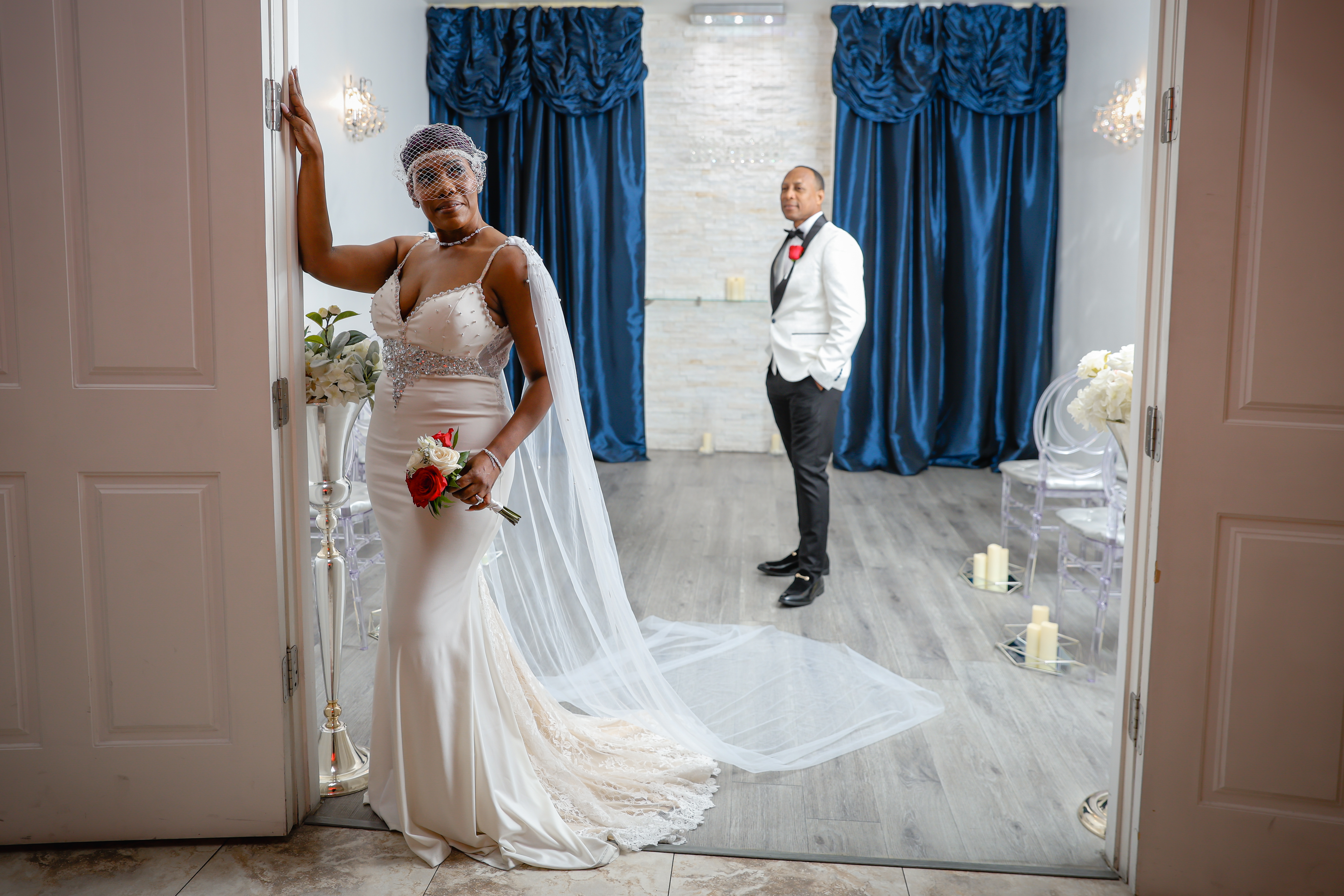Newlyweds romantically touch foreheads in their gorgeously lit wedding chapel