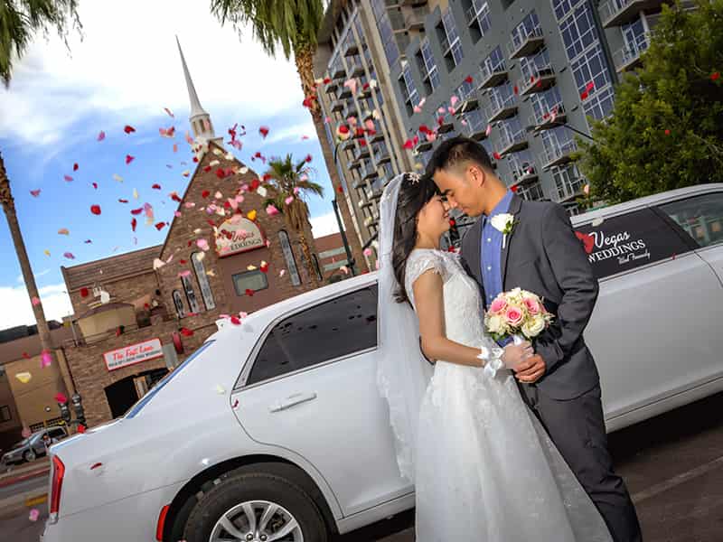 Flower shower in front of the chapel & limo