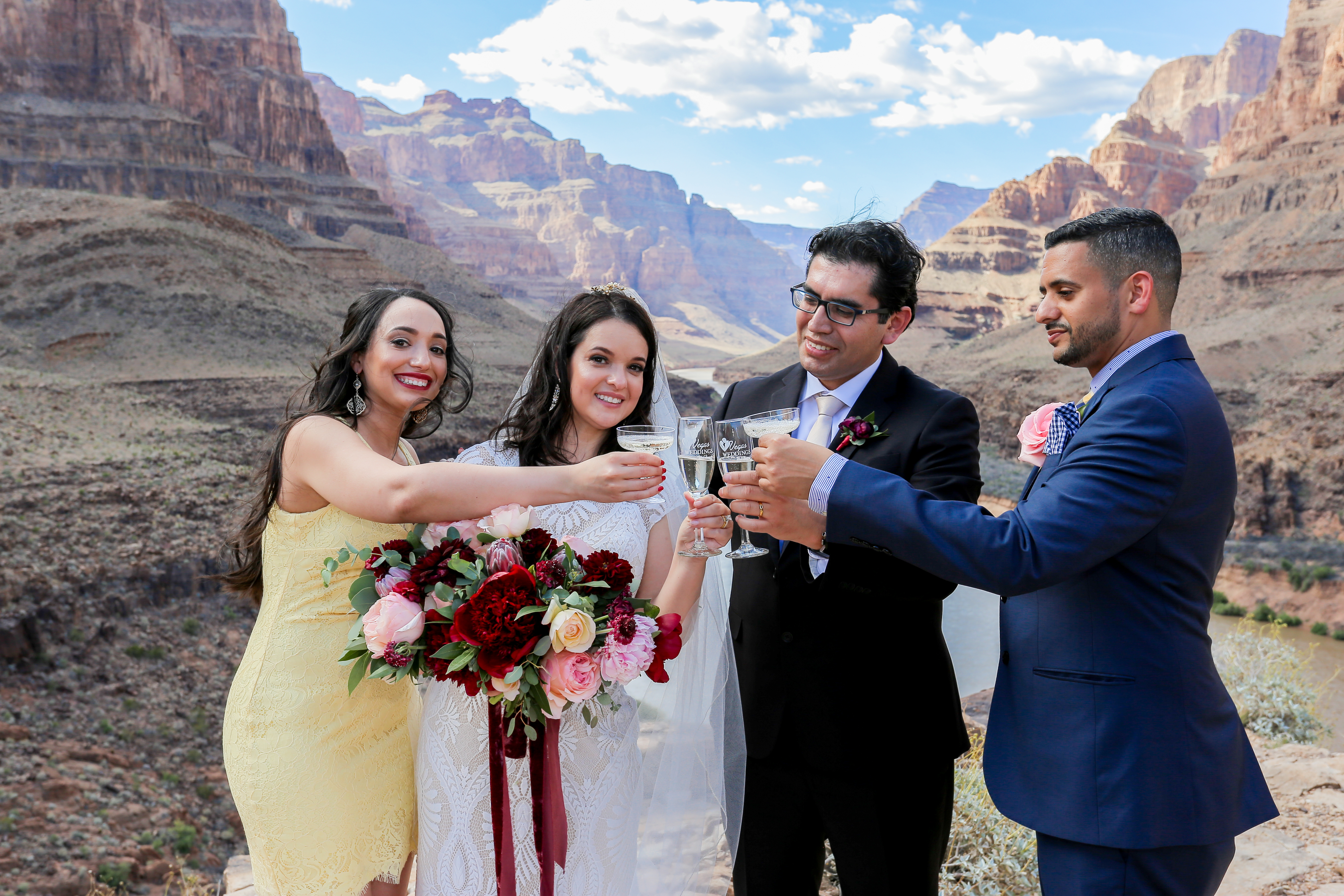 A radiant and super fashionable bride  with her husband at the floor of the Grand Canyon