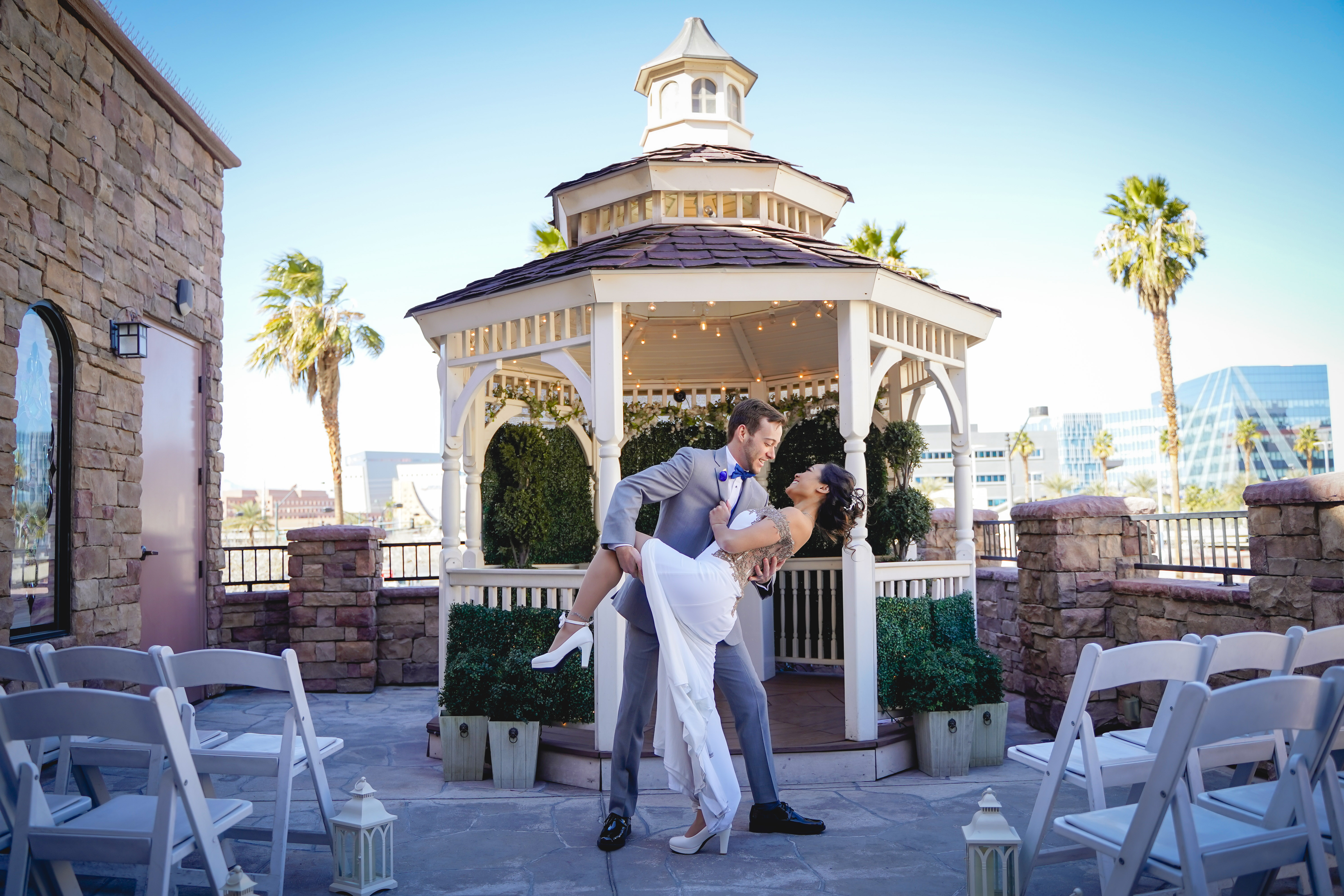 A couple sharing a kiss on their wedding day at an outdoor venue in Vegas