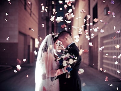 Wedding couple in a downtown Las Vegas alley with fresh rose petals cascading down all around them - Indulge Package