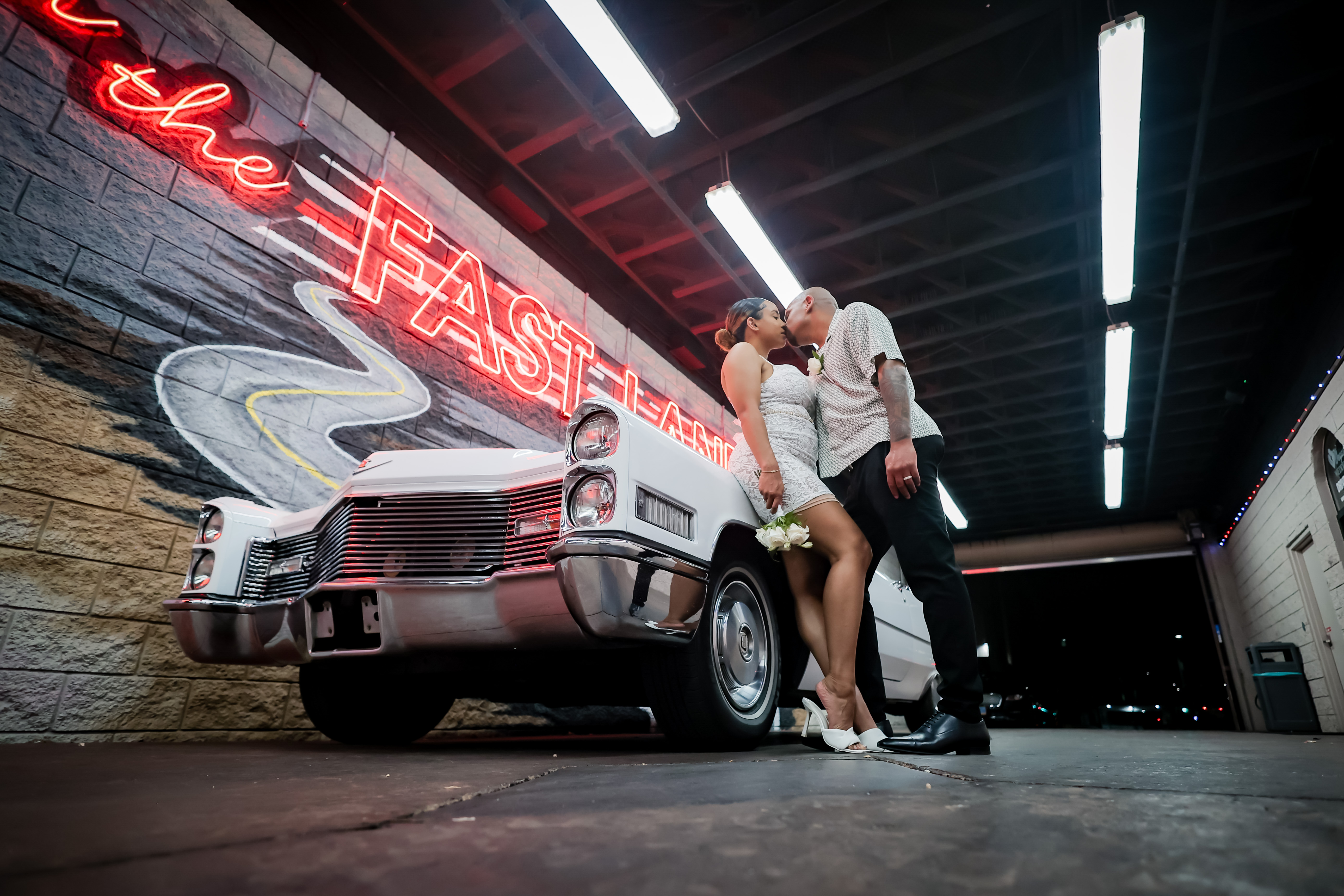 Happy couple celebrating their wedding day in front of a Las Vegas Mural