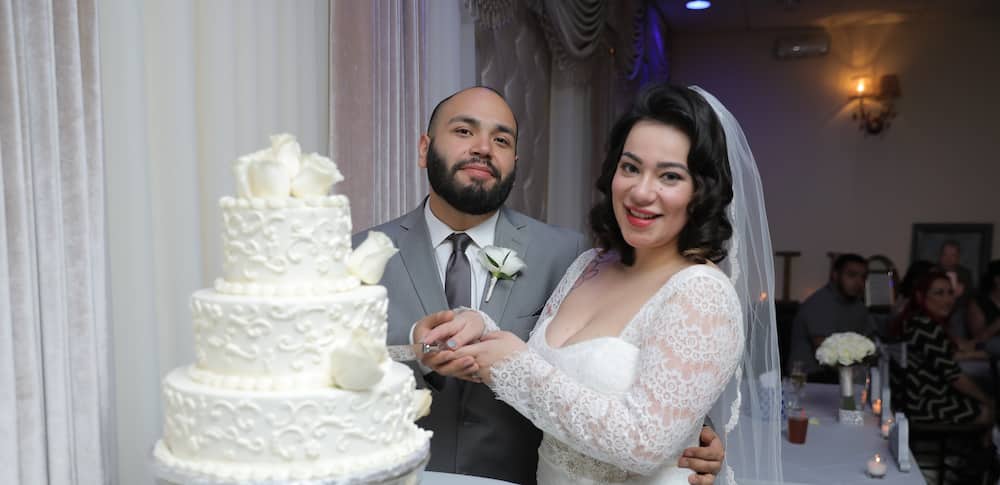 A groom carrying his little daughter on his vow renewal ceremony