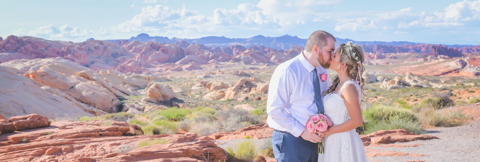 Newlyweds kiss in a gorgeous panoramic view of the Valley of Fire State Park 
